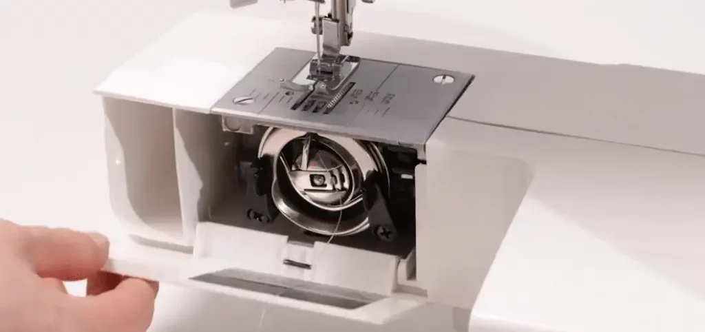 sewing machine bobbin cover and bobbin release