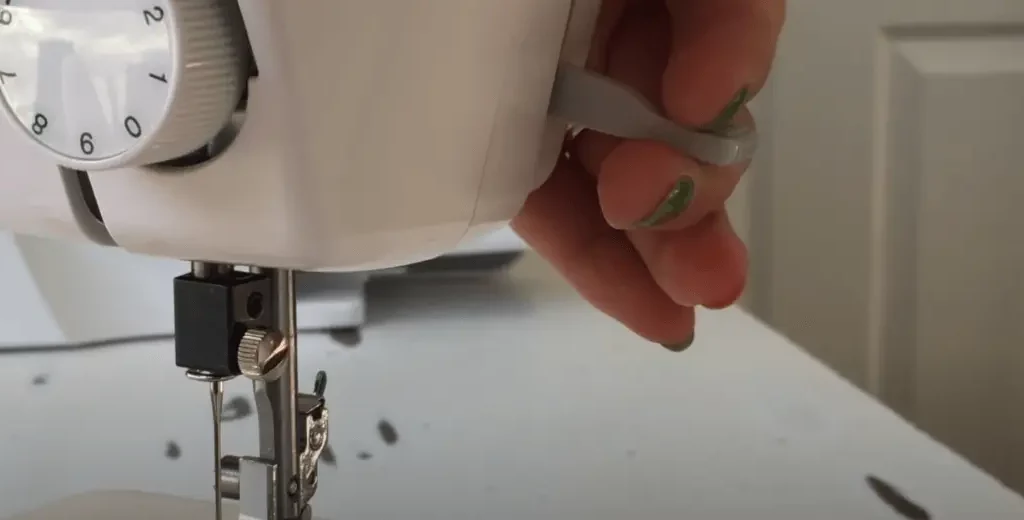 Lower the presser foot onto the fabric