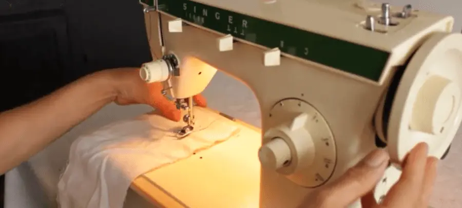 use the hand wheel to move the needle