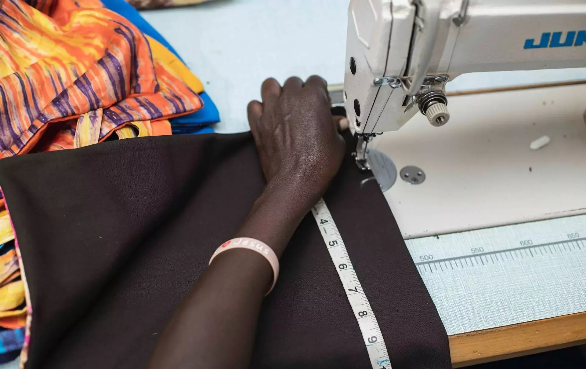 A woman learns to sew with a sewing machine