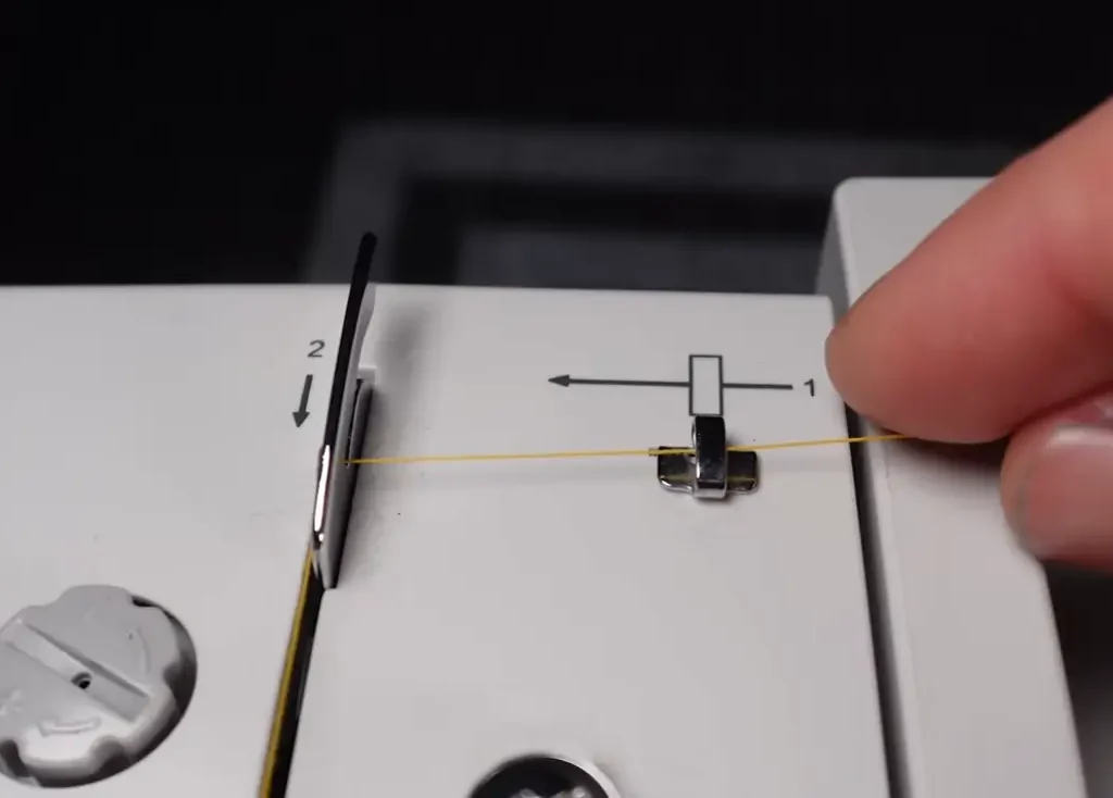 Thread through the tension discs