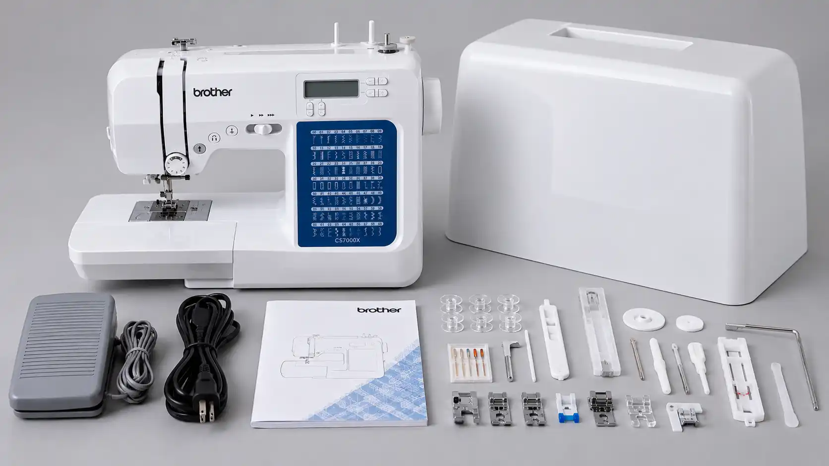 Brother CS7000X sewing machine with its protective cover, foot pedal, manual, and included accessories.